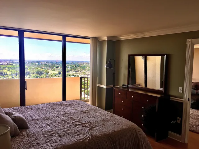 a large bed sitting in a bedroom next to a bathroom