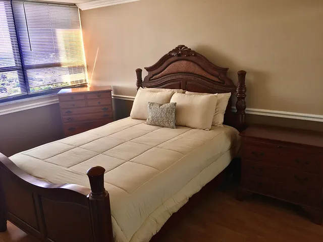 a bedroom with a bed and a lamp