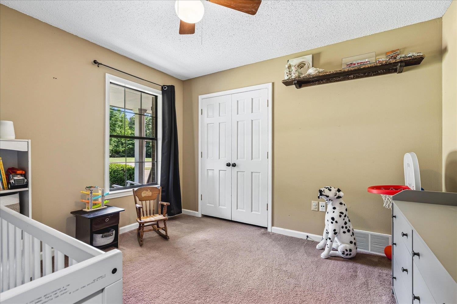 5711 Yale Road Bartlett, TN 38134 - Photo 16 of 29 Room featuring tan walls, light brown carpet, and a window with exterior views