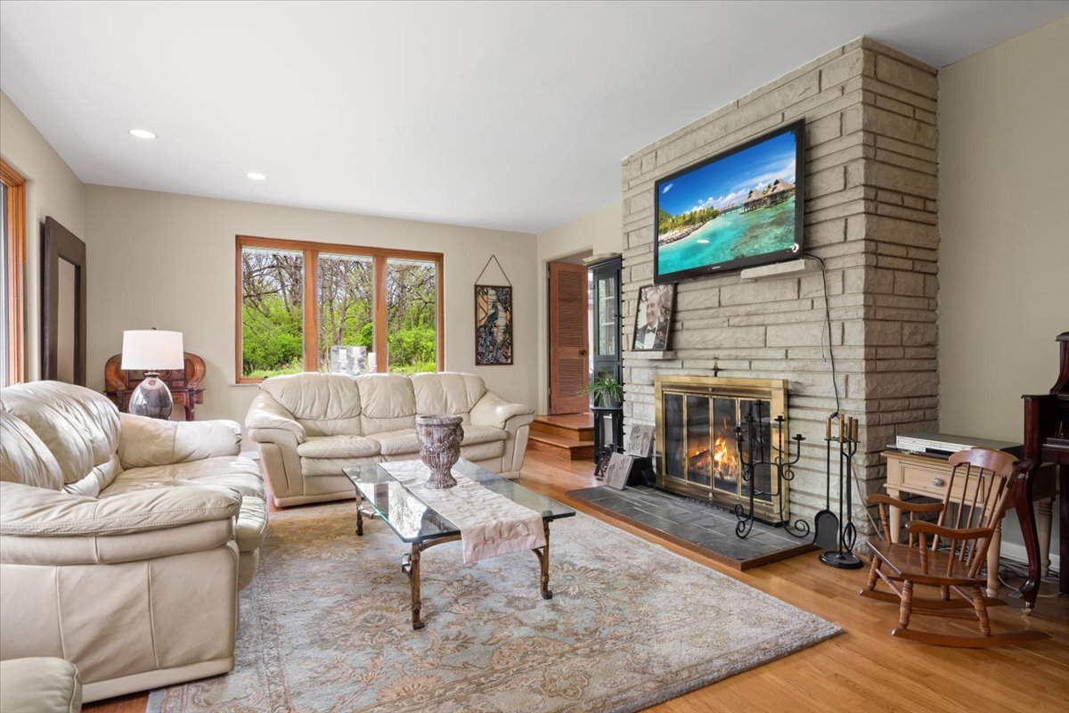 22446 North Old Barrington Road Barrington, IL 60618 - Photo 11 of 49 a living room with furniture a flat screen tv and a fireplace