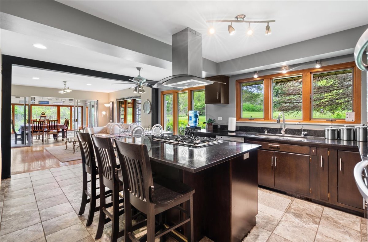 22446 North Old Barrington Road Barrington, IL 60618 - Photo 14 of 49 a kitchen with large windows and dining table