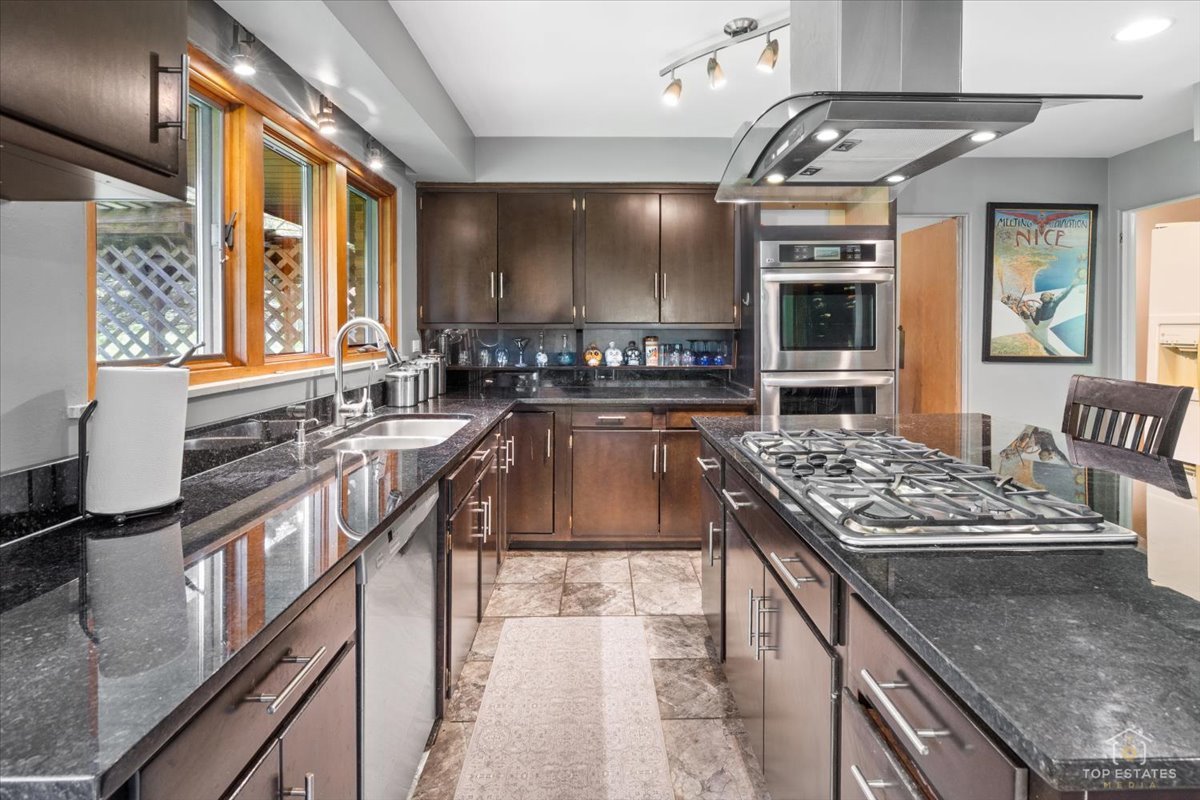 22446 North Old Barrington Road Barrington, IL 60618 - Photo 15 of 49 a kitchen with stainless steel appliances granite countertop a stove and a sink