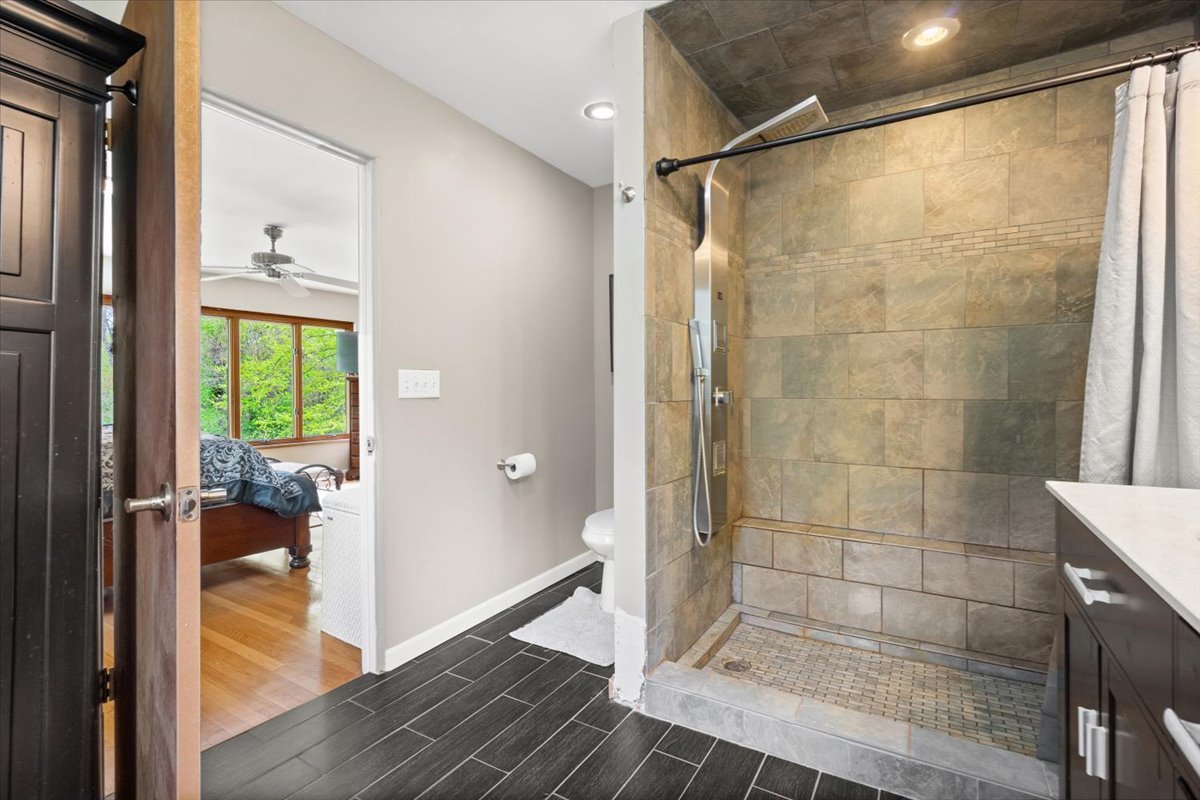 22446 North Old Barrington Road Barrington, IL 60618 - Photo 26 of 49 a bathroom with a glass shower door and a window
