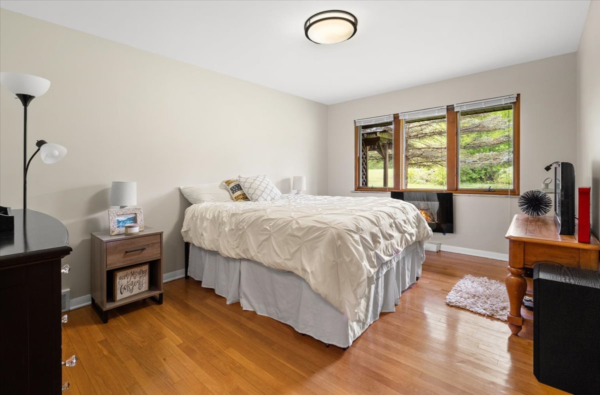 22446 North Old Barrington Road Barrington, IL 60618 - Photo 28 of 49 a bedroom with a bed and wooden floor
