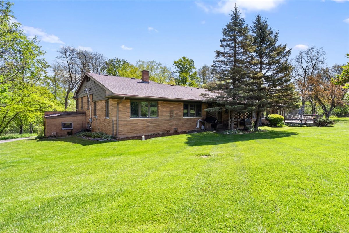 22446 North Old Barrington Road Barrington, IL 60618 - Photo 39 of 49 a front view of a house with a garden and trees