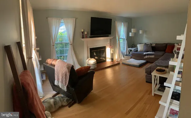 a living room with furniture fireplace and flat screen tv