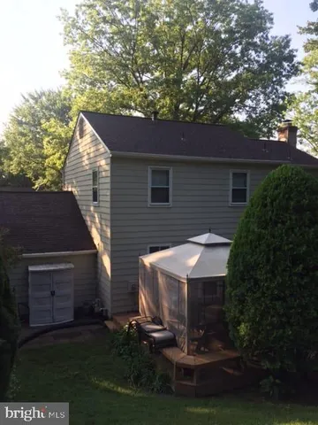 a view of a house with yard and sitting area