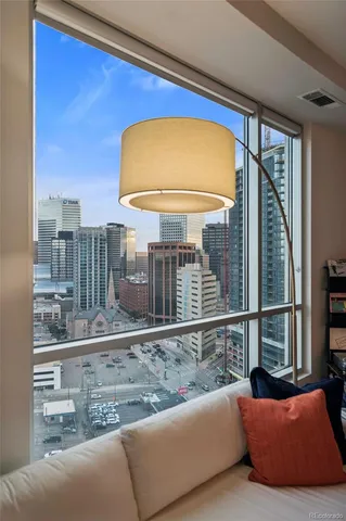 a dining room with furniture and a floor to ceiling window