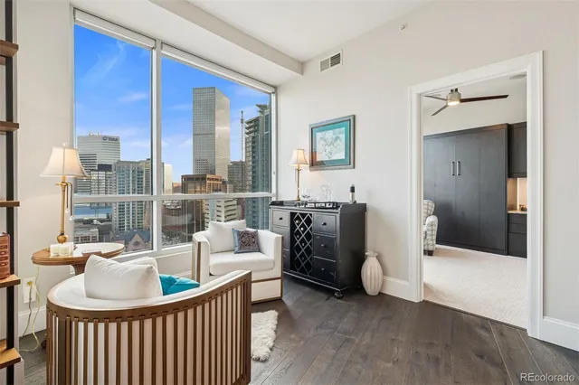 a living room with furniture and large windows