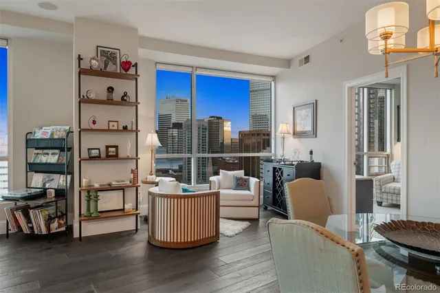 a living room with furniture and a floor to ceiling window