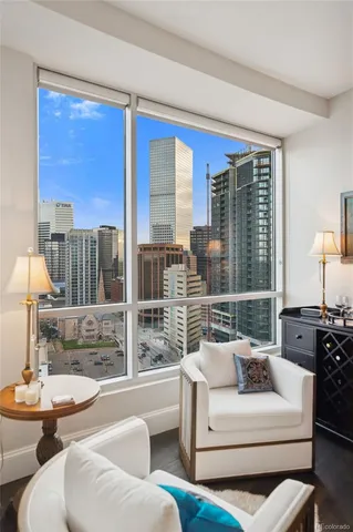 a view of a dining room with furniture a chandelier and wooden floor