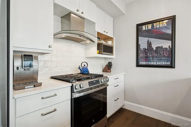 a bedroom with a bed lamp and a large window