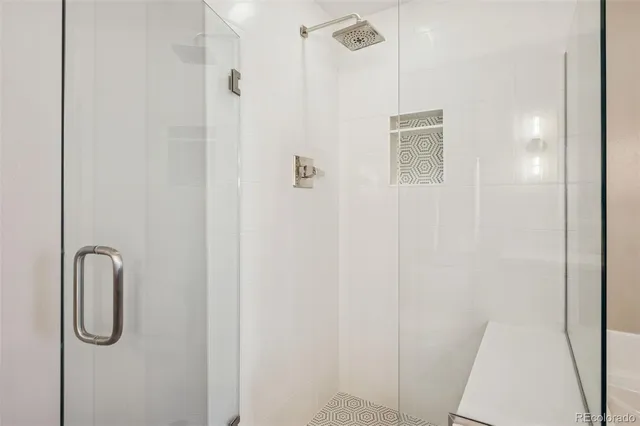 a living room with furniture a flat screen tv and a floor to ceiling window