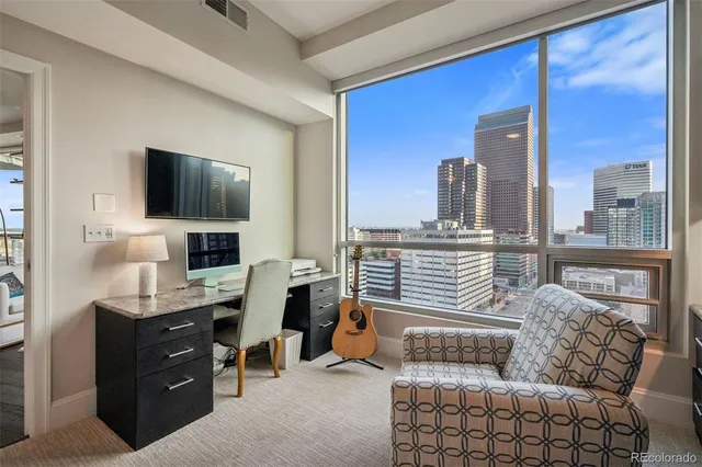 a bathroom with a granite countertop toilet sink and mirror