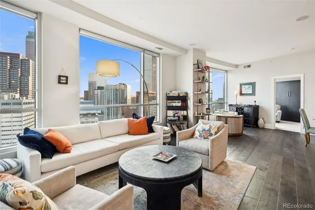a living room with furniture and a floor to ceiling window