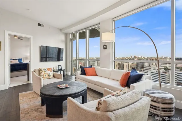 a living room with furniture a rug and a book shelf