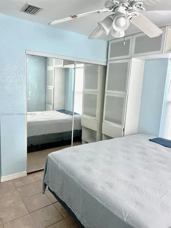 a bedroom with two beds and a chandelier