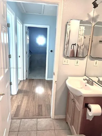 a bathroom with a sink and mirror