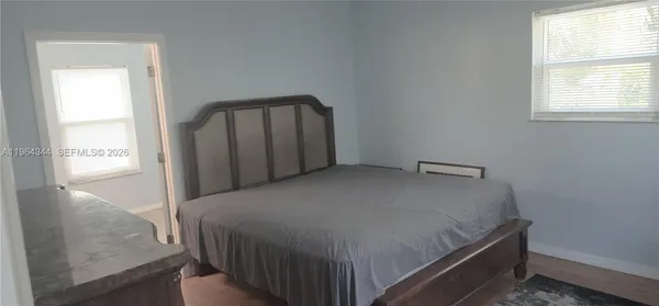a bed sitting in a bedroom next to a window