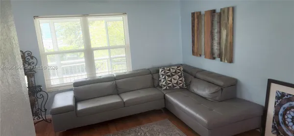 a living room with furniture and a window