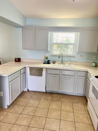 a kitchen with a sink a stove a microwave and cabinets