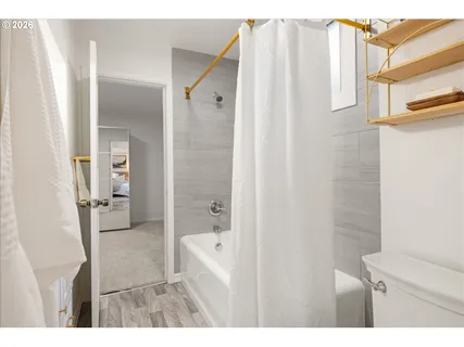 a bathroom with a shower and a sink