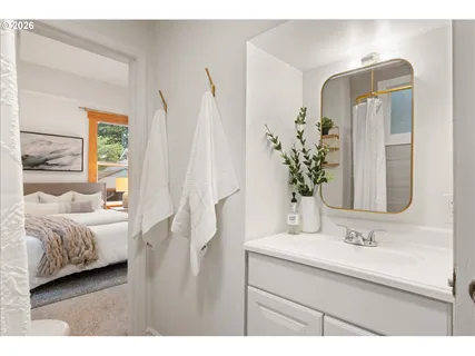 a en suite bathroom with a double vanity sink and a mirror
