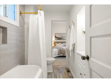 a bathroom with a bathtub and a shower