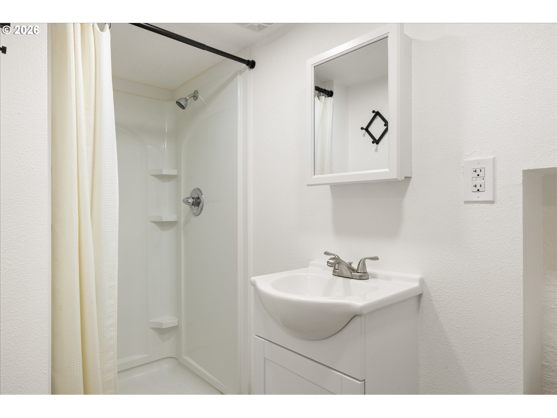 2055 North Alberta Street Portland, OR 97217 - Photo 32 of 38 a bathroom with a sink a mirror and a shower