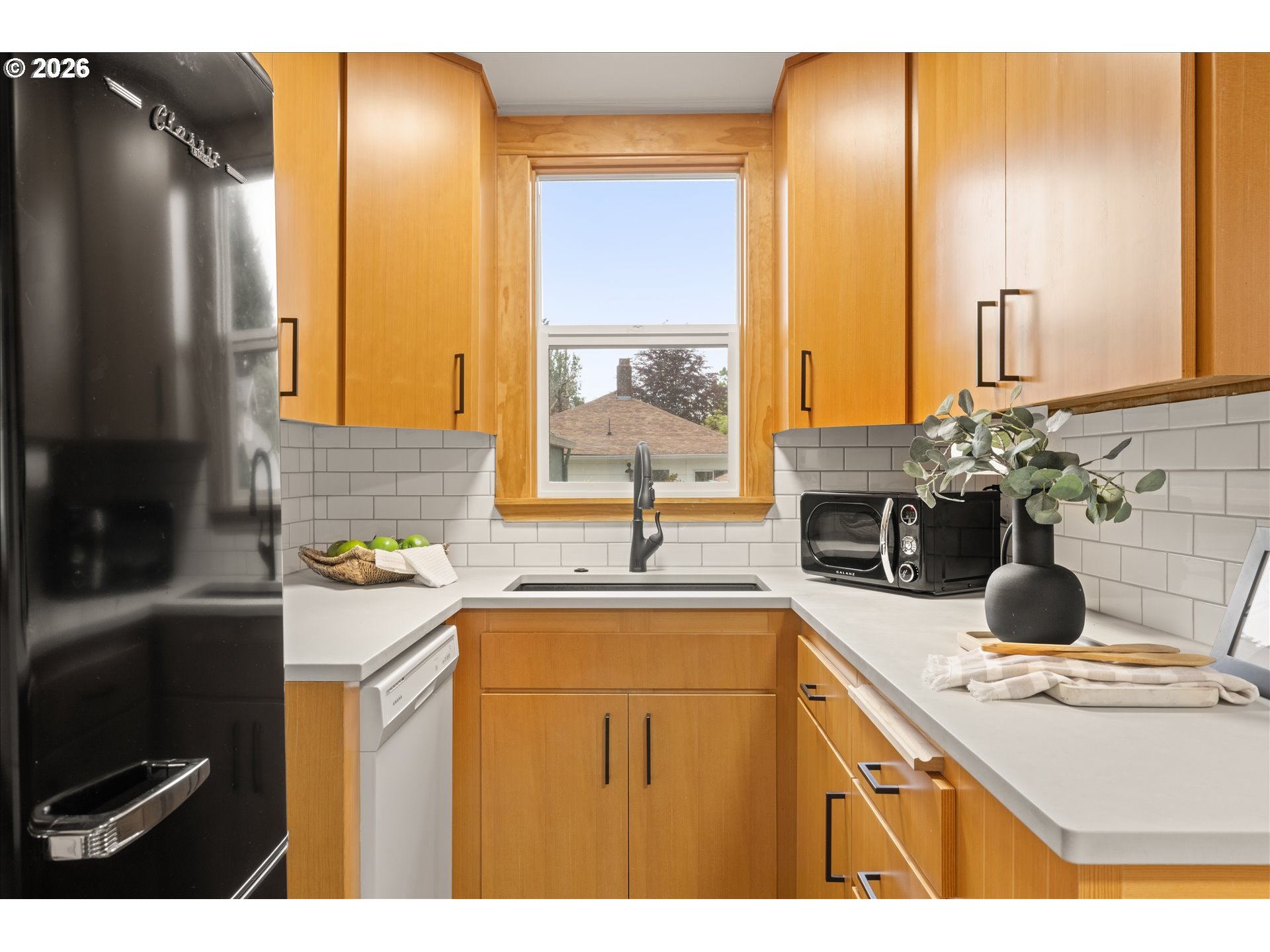 2055 North Alberta Street Portland, OR 97217 - Photo 10 of 38 a kitchen with a sink and a refrigerator
