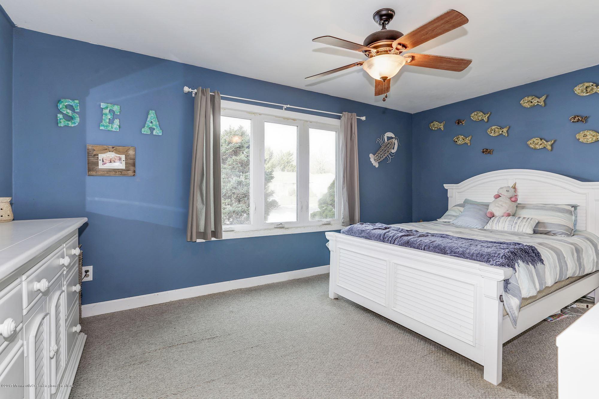 27 Long Road Freehold, NJ 07728 - Photo 12 of 25 a bedroom with a bed dresser and a window
