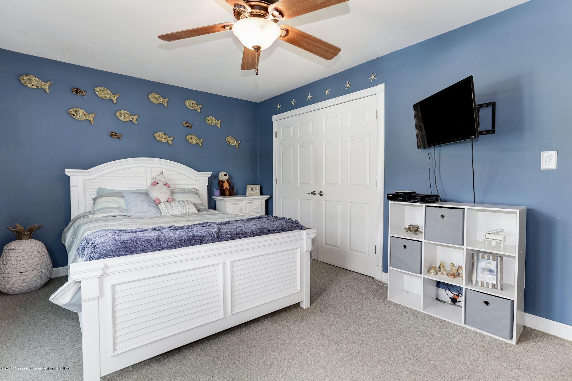 27 Long Road Freehold, NJ 07728 - Photo 13 of 25 a bedroom with a bed and a flat screen tv
