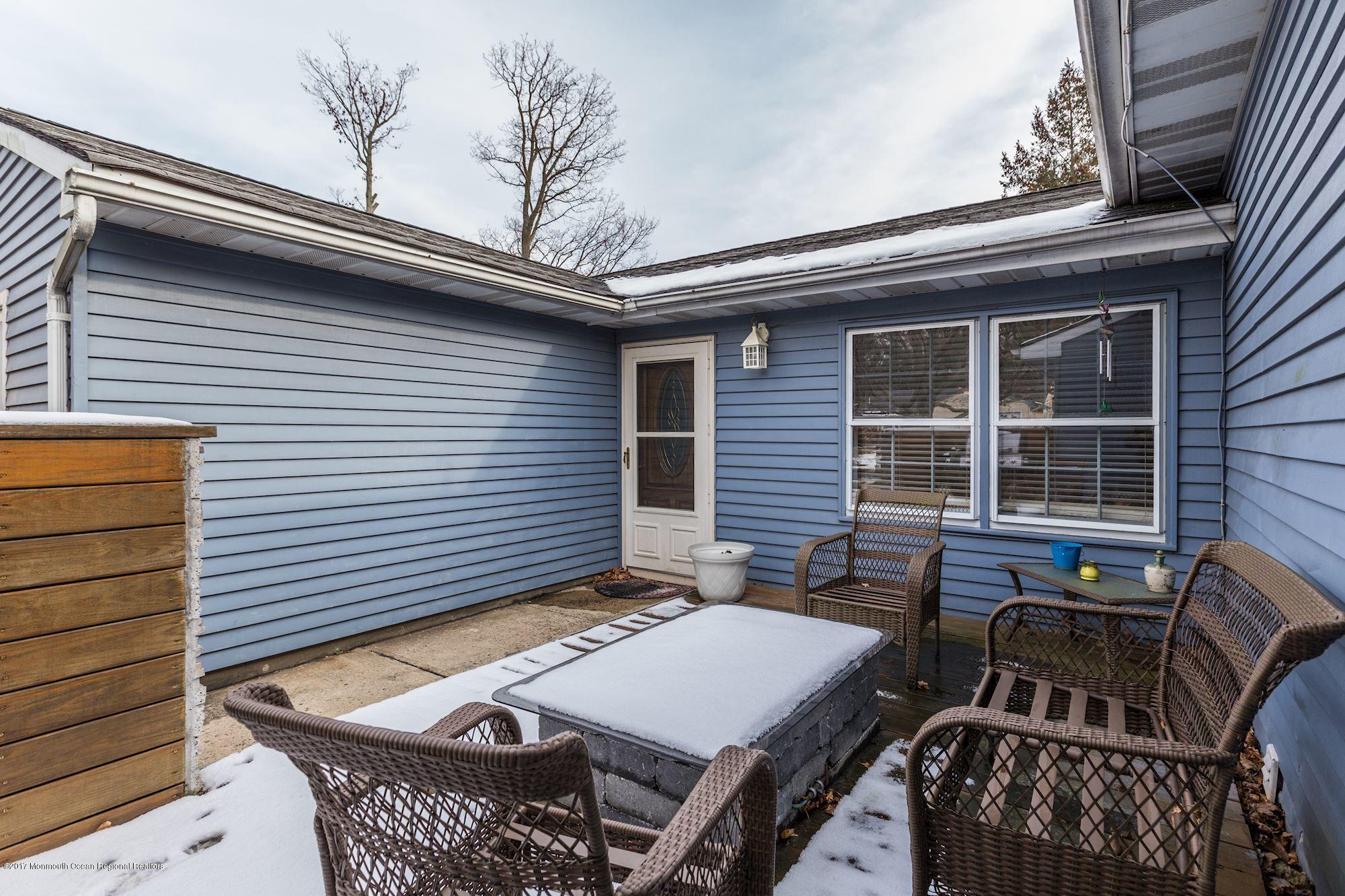 27 Long Road Freehold, NJ 07728 - Photo 23 of 25 a view of a patio with a table and chairs