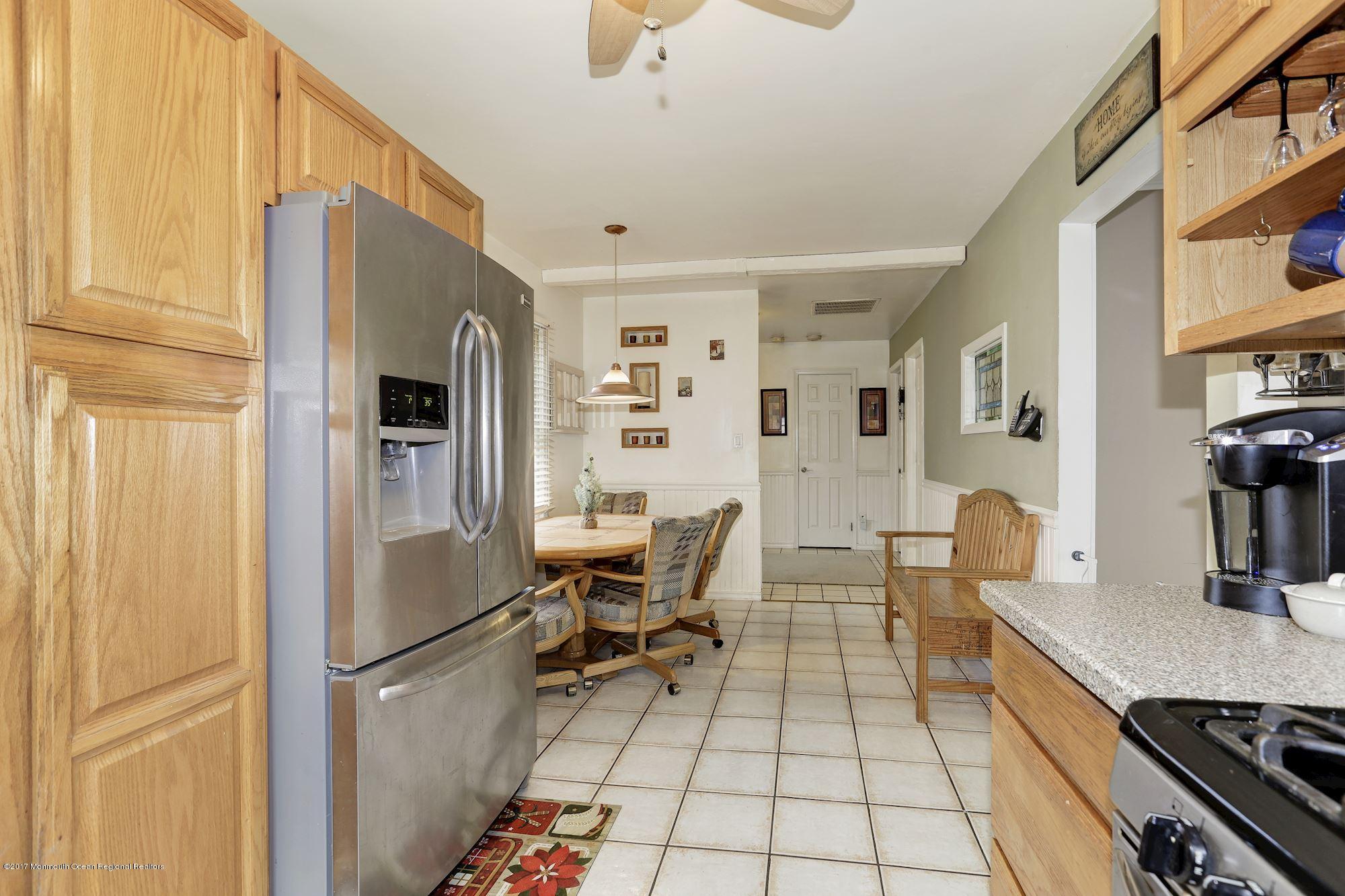 27 Long Road Freehold, NJ 07728 - Photo 8 of 25 a living room with stainless steel appliances furniture and a kitchen view
