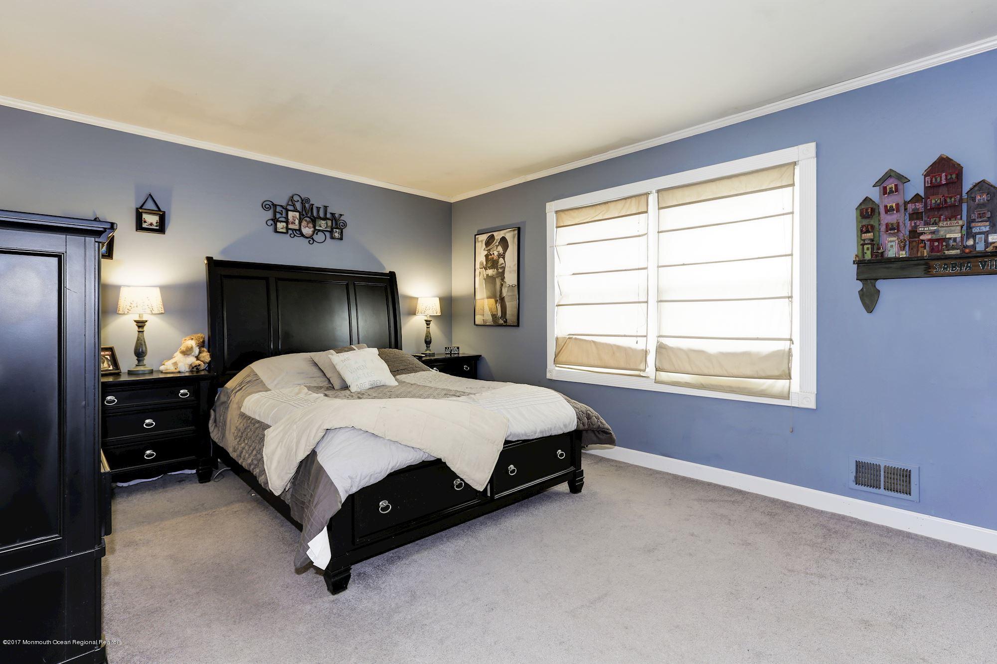 27 Long Road Freehold, NJ 07728 - Photo 9 of 25 a spacious bedroom with a bed and a window