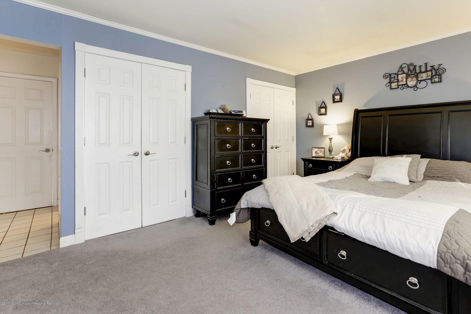 27 Long Road Freehold, NJ 07728 - Photo 10 of 25 a bed room with a bed and a television