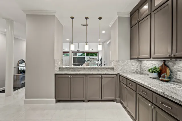 a kitchen with stainless steel appliances granite countertop a sink and dishwasher a stove top oven with wooden floor