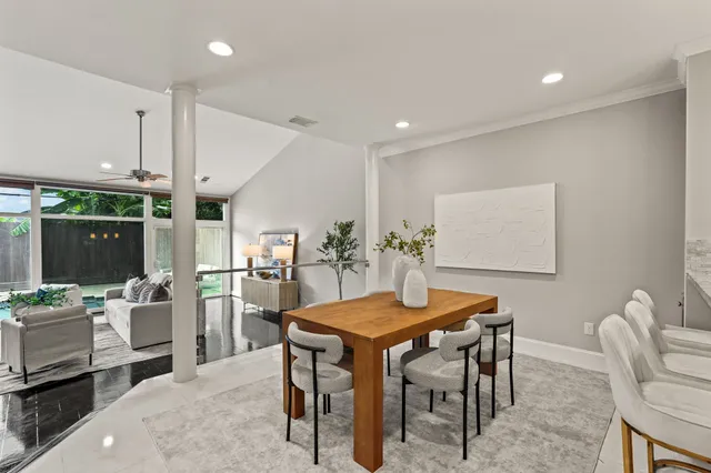 a dining room with furniture and window