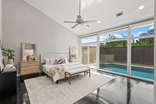 a spacious bedroom with a bed and large window