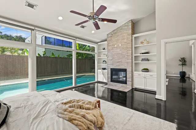 a spacious bedroom with a bed and a fireplace