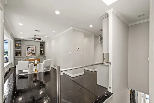 a workspace with furniture and floor to ceiling window