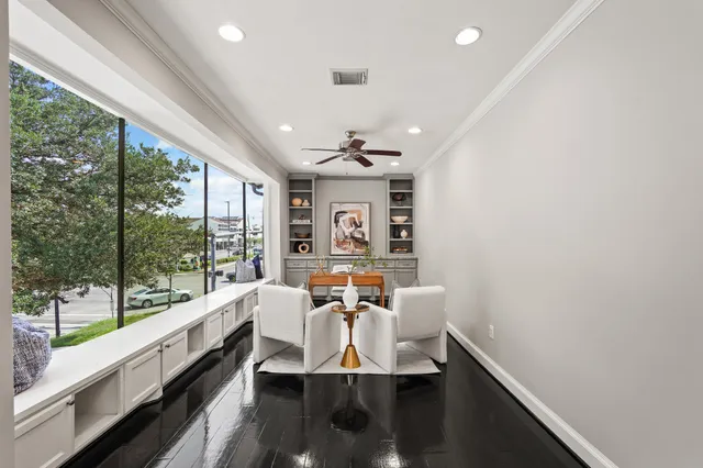 a view of a dining room with furniture a chandelier and wooden floor