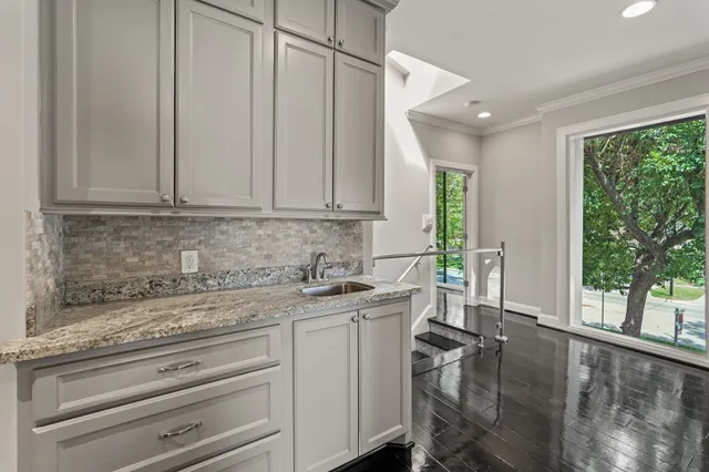 a view of a kitchen with a sink a window and furniture