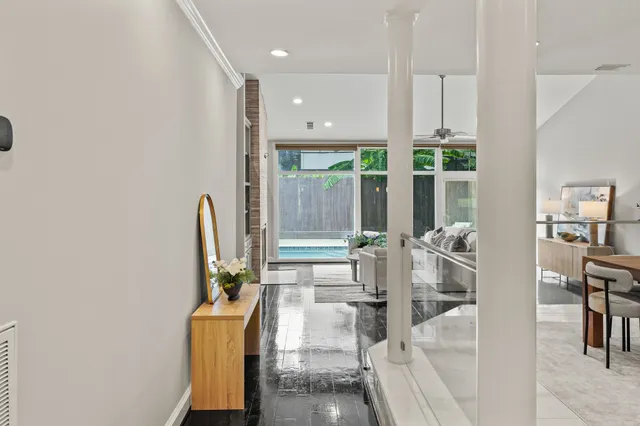 a living room with furniture a large window and a flat screen tv