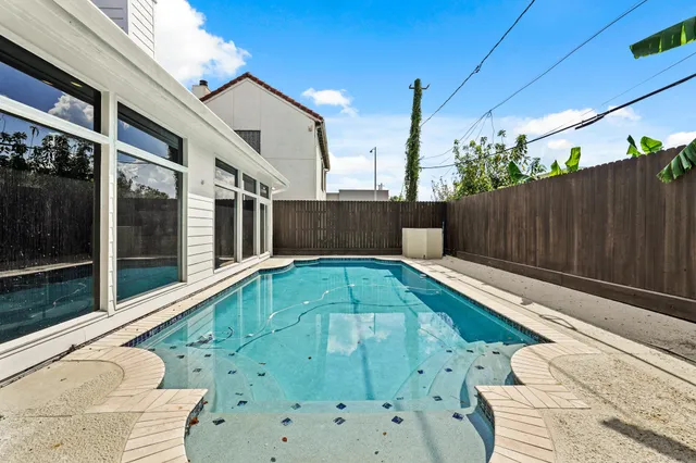 a view of house and a chairs and table in the patio
