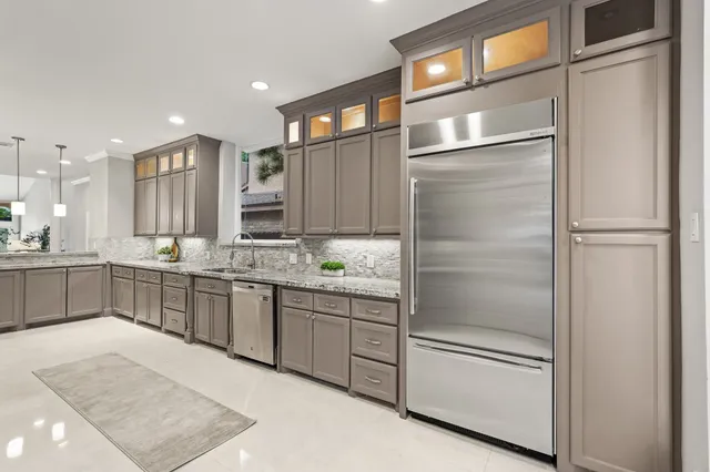 a large kitchen with a refrigerator and a sink