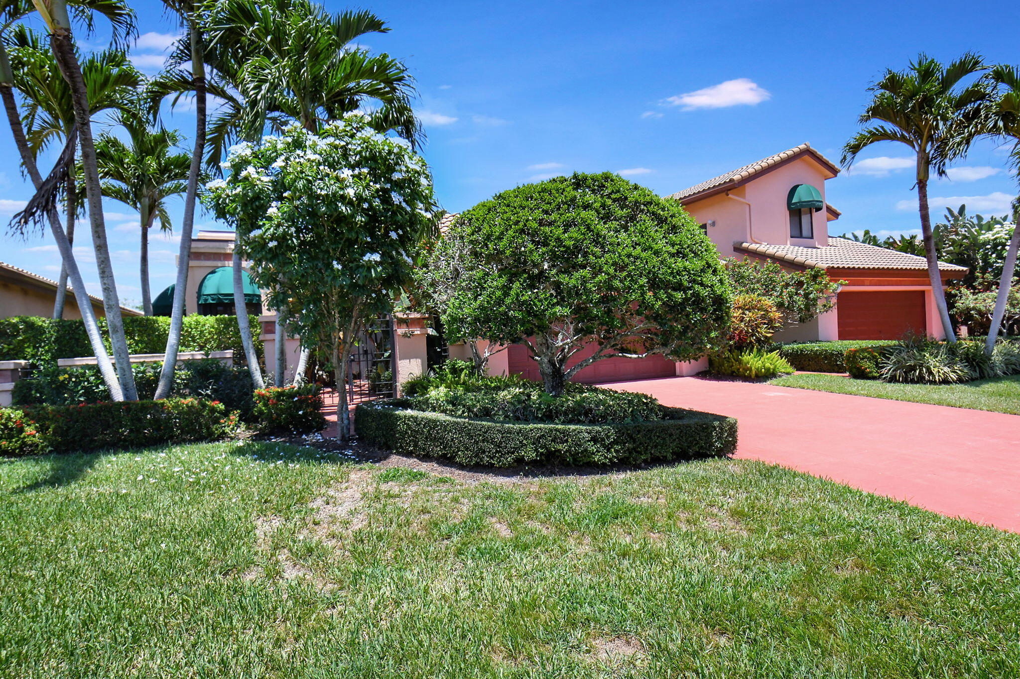 6403 Via Rosa Boca Raton, FL 33433 - Photo 5 of 46 a front view of a house with a yard and garage