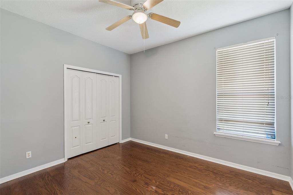 774 Lancer Circle Ocoee, FL 34761 - Photo 21 of 35 a view of an empty room with wooden floor and a window
