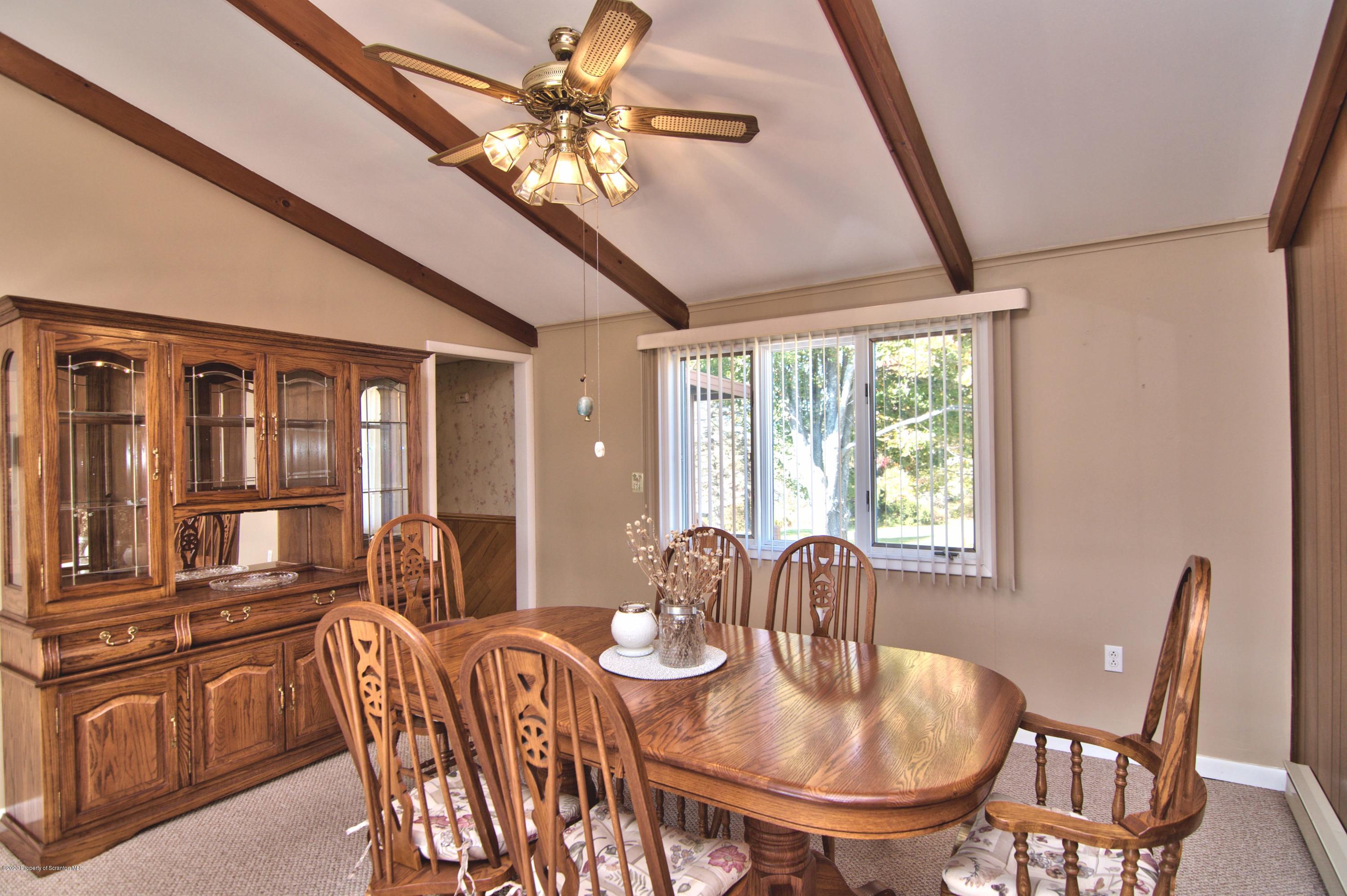 2151 Aberdeen Road Moscow, PA 18444 - Photo 14 of 65 a dining room with furniture a flat screen tv and a chandelier