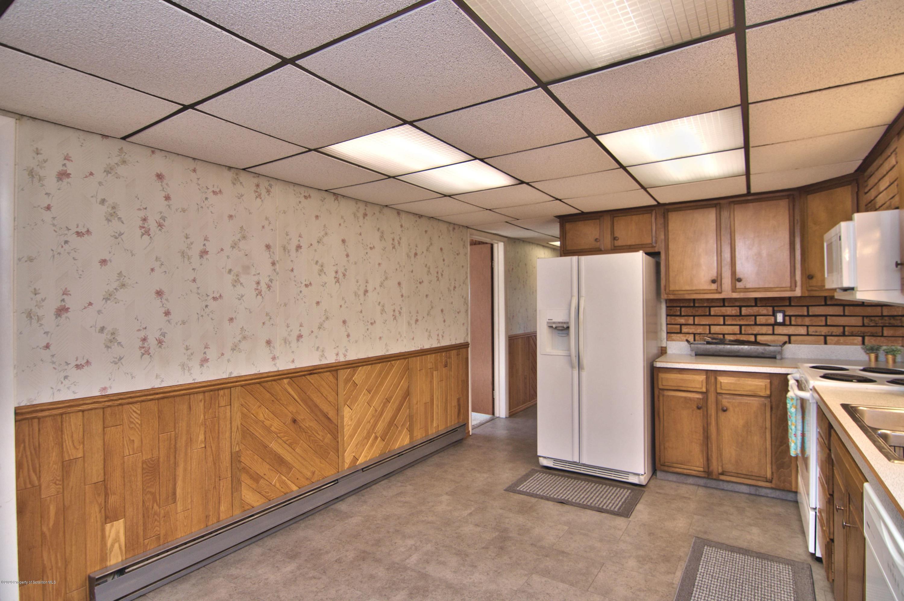 2151 Aberdeen Road Moscow, PA 18444 - Photo 21 of 65 a view of a refrigerator in kitchen and cabinets